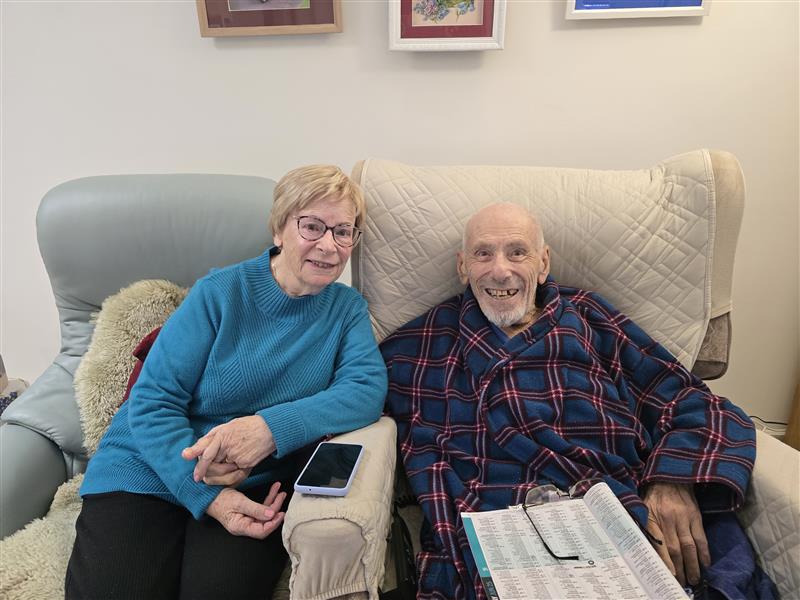 Koorootang Court retirement village residents Natalie and Leon sitting in armchairs in their retirement home